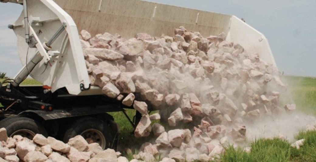Side Dump trailer dumping rock