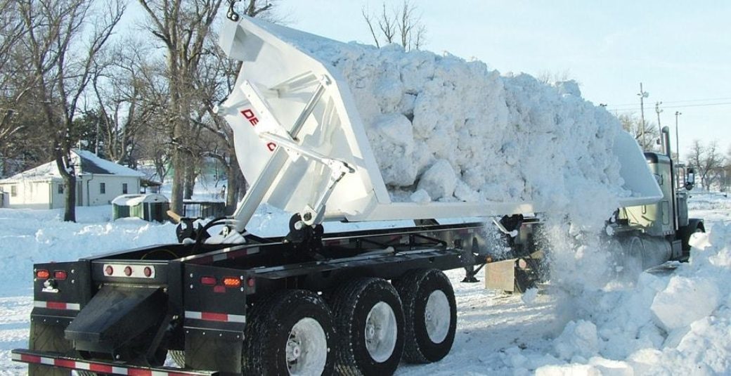 Side Dump trailer dumping snow